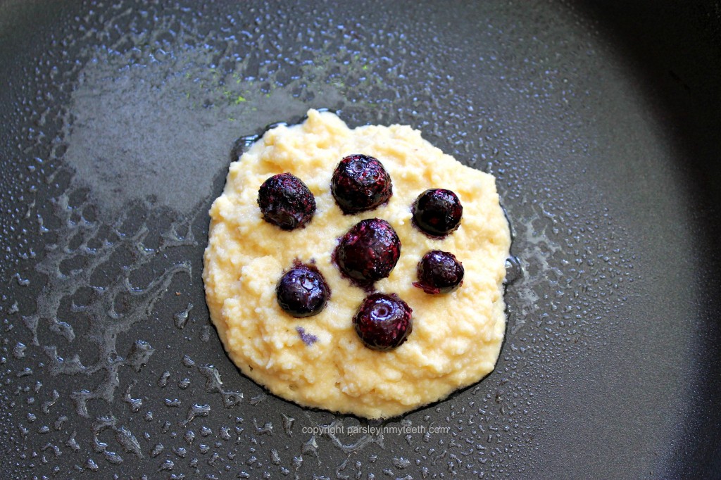 blueberries on pancake in pan