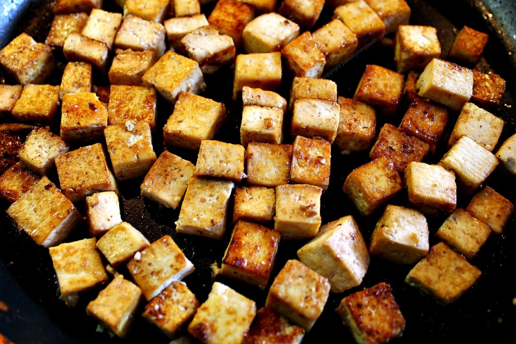 cubed marinated tofu in frying pan
