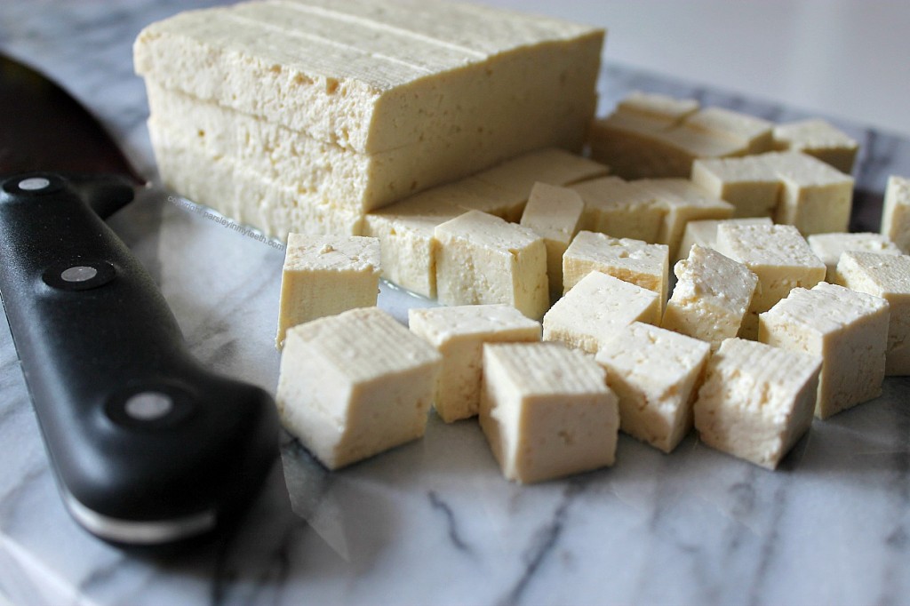 cubed tofu with knife