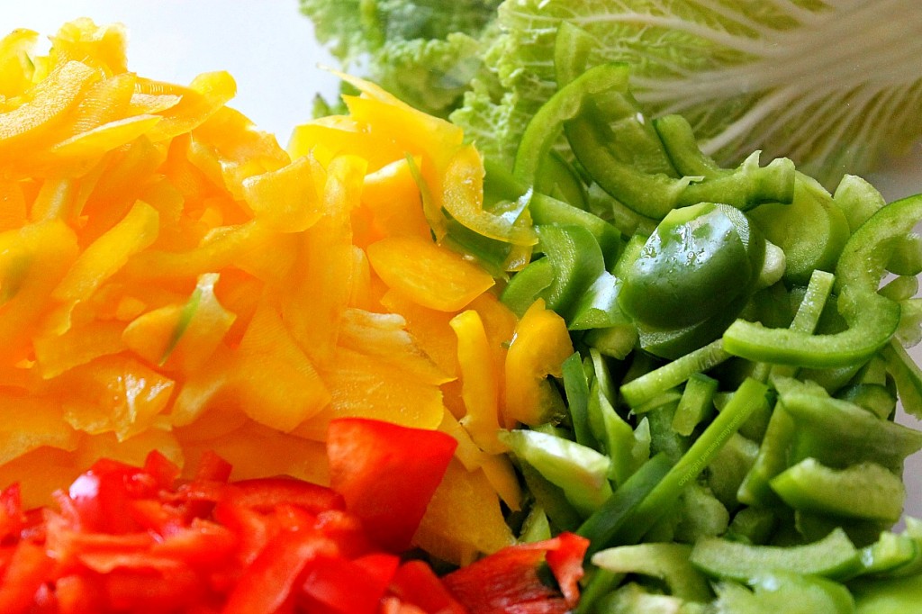 sliced red yellow green bell peppers with napa cabbage