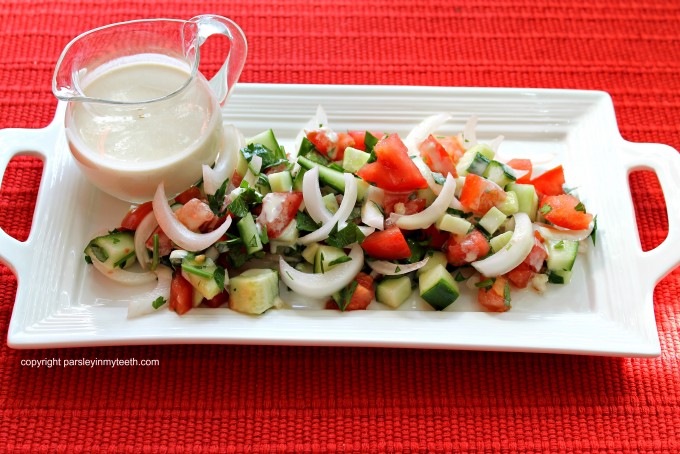 Tomato Cucumber Salad with Onions Parsley and Tahini Dressing